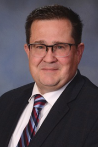Official portrait of Gregory Koenig